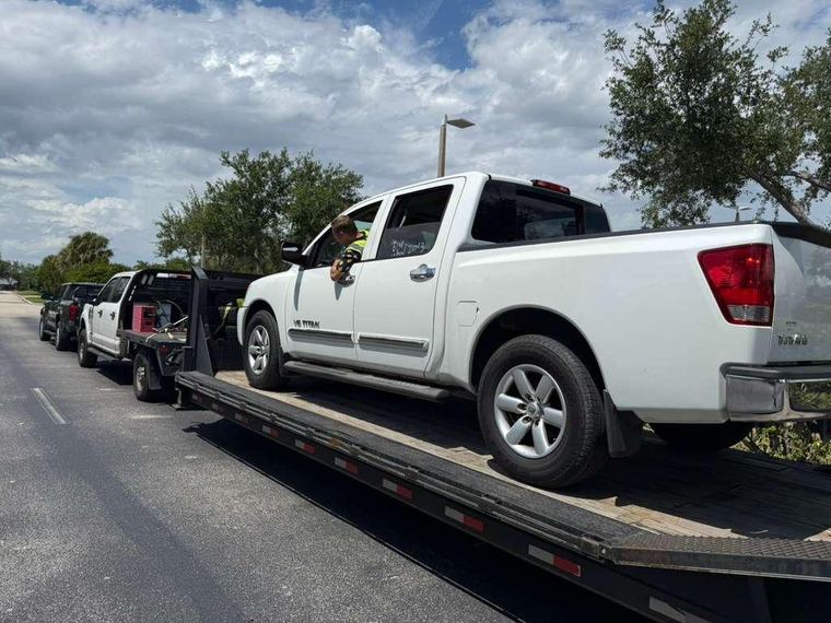 Shoppiis F-250 and gooseneck trailer with a loaded vehicle on a Southeast route