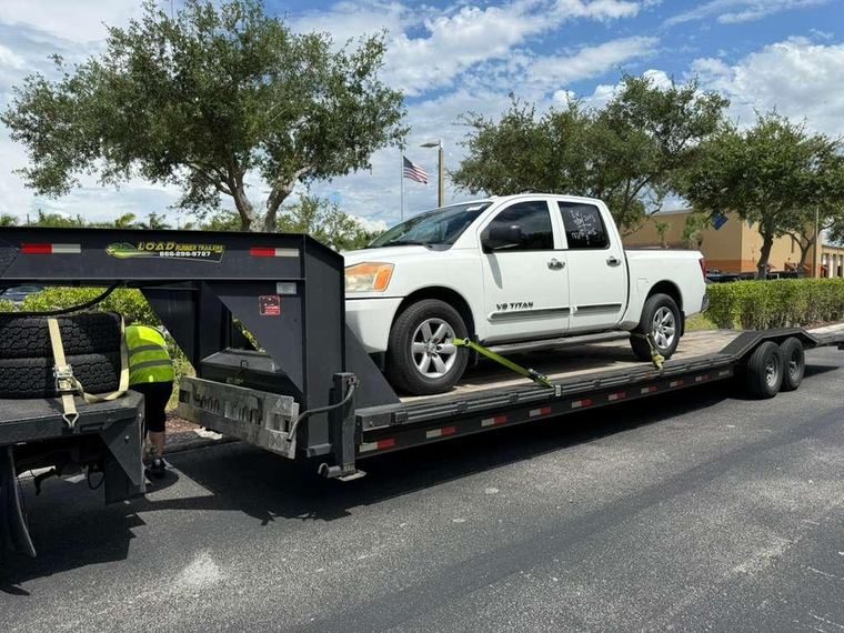 Secured customer vehicle on the Shoppiis trailer, side view